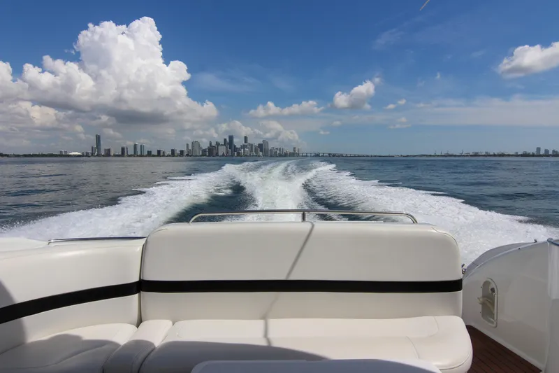Slide: The Image of 2008 Formula 400 Super Sport boat cruising with city skyline and ocean view. - 21