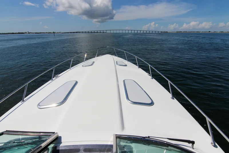 Slide: The Image of 2008 Formula 400 Super Sport boat cruising on open water under a clear sky. - 23