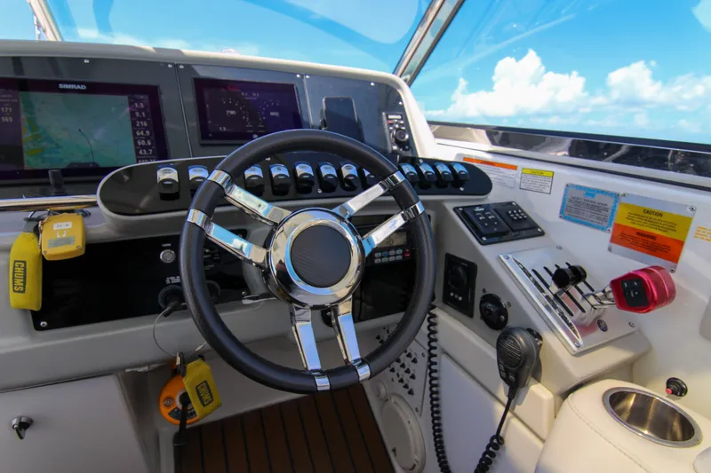 Slide: The Image of Cockpit of 2008 Formula 400 Super Sport boat with steering wheel and navigation controls. - 30