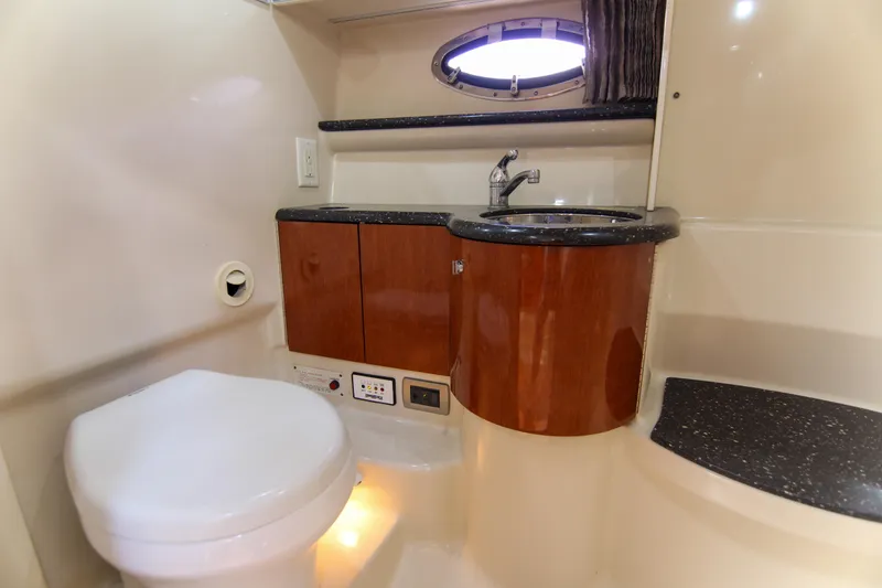 Slide: The Image of 2008 Formula 400 Super Sport yacht bathroom with sink, toilet, and porthole window. - 36