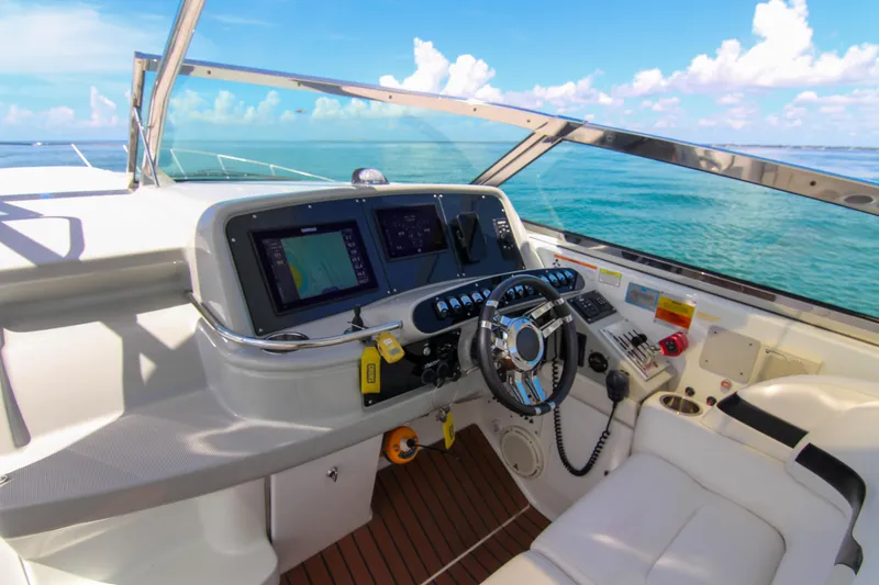Slide: The Image of 2008 Formula 400 Super Sport yacht helm with ocean view, featuring modern navigation equipment. - 7