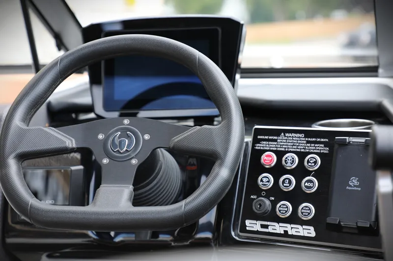 Slide: The Image of 2024 Scarab 235 Wake ID dashboard with steering wheel and control panel. - 10