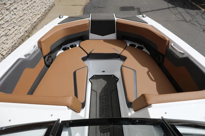 Slide: The Image of 2024 Scarab 235 Wake ID boat interior with tan seating and modern design. - 2