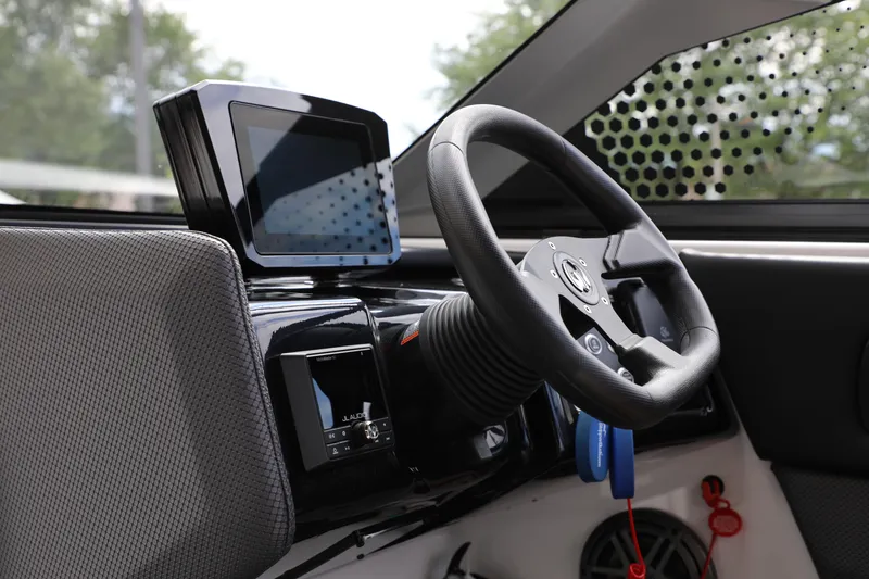 Slide: The Image of 2024 Scarab 235 Wake ID boat dashboard with steering wheel and digital display. - 21