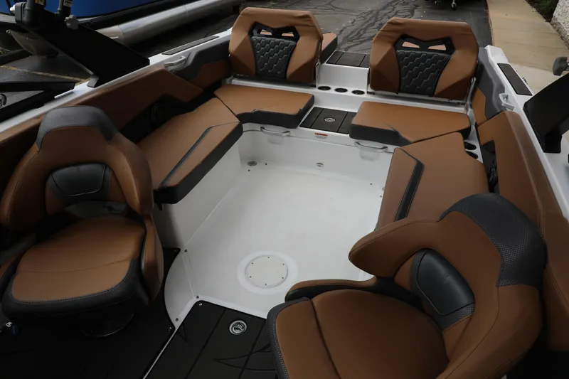 Slide: The Image of 2024 Scarab 235 Wake ID boat interior with brown and black seating. - 3