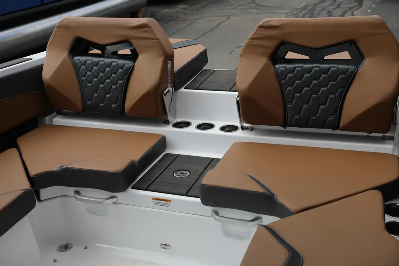 Slide: The Image of 2024 Scarab 235 Wake ID boat interior with brown and black seating. - 4