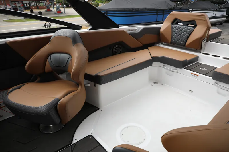 Slide: The Image of 2024 Scarab 235 Wake ID boat interior with brown and black seating. - 5