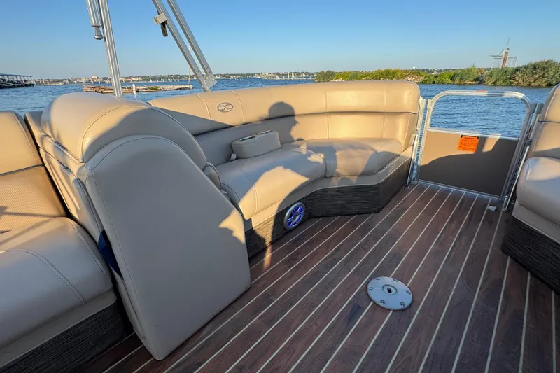 Slide: The Image of 2016 Xcursion 23RFE pontoon boat interior with beige seating and wood-style flooring. - 9