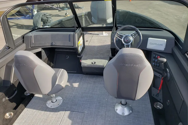Slide: The Image of 2026 Alumacraft Competitor 175X Sport interior with dual seats and Garmin navigation system. - 11
