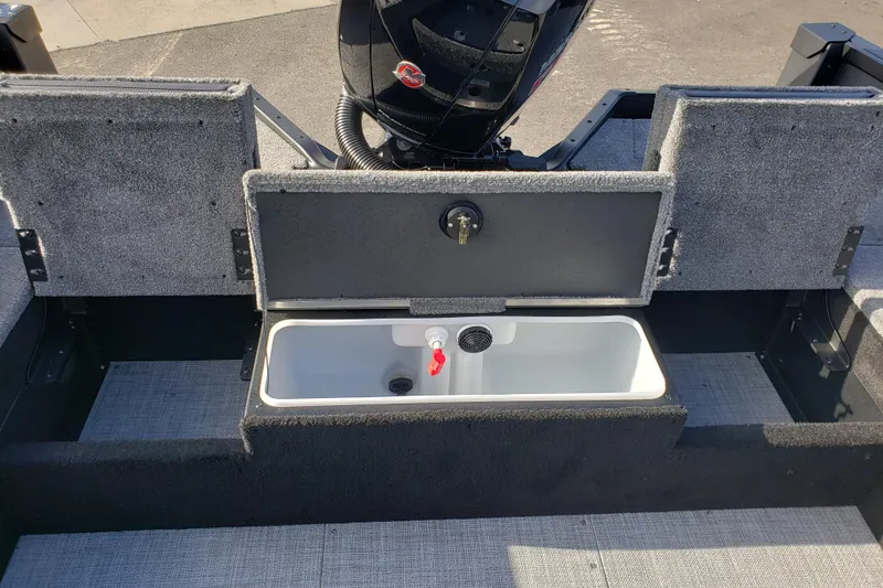 Slide: The Image of 2026 Alumacraft Competitor 175X Sport boat interior with open storage compartment. - 13