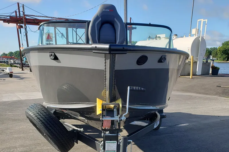 Slide: The Image of 2026 Alumacraft Competitor 175X Sport boat on trailer at marina. - 2