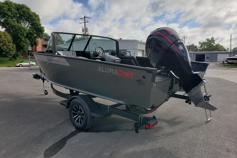 Slide: The Image of 2026 Alumacraft Competitor 175X Sport boat on trailer, parked outdoors. - 3