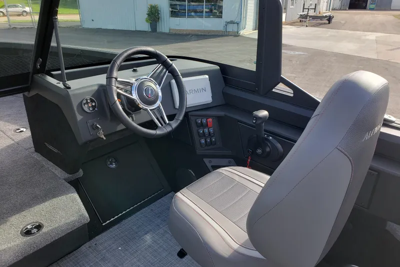 Slide: The Image of Interior of 2026 Alumacraft Competitor 175X Sport boat with steering wheel and controls. - 6