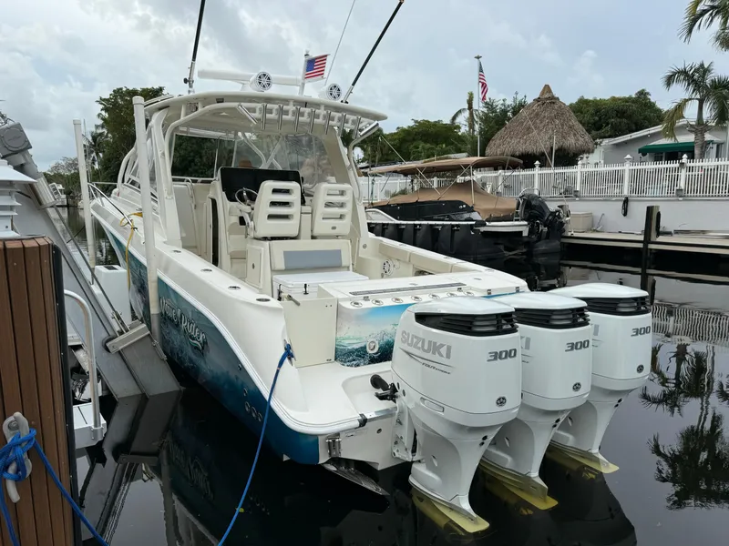 Slide: The Image of 2010 Hydra-Sports 3500 VX boat with triple Suzuki 300 engines docked in marina. - 11