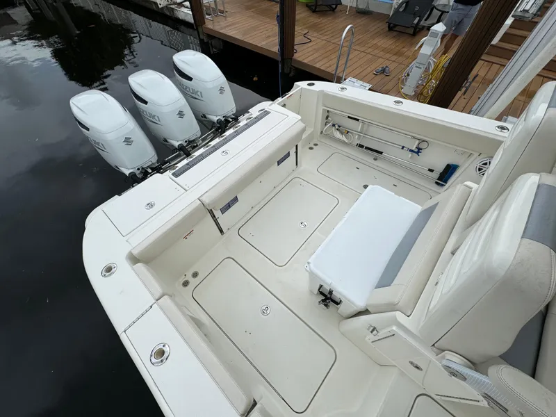 Slide: The Image of 2010 Hydra-Sports 3500 VX boat with triple outboard engines docked at marina. - 18