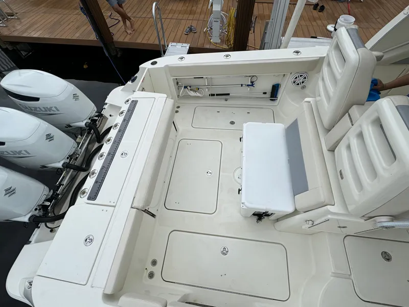 Slide: The Image of 2010 Hydra-Sports 3500 VX boat deck with seating and Suzuki outboard engines. - 19