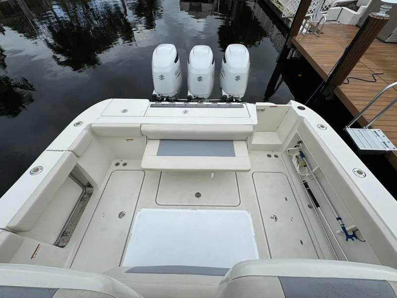 Slide: The Image of 2010 Hydra-Sports 3500 VX boat with triple outboard engines, docked on calm water. - 20