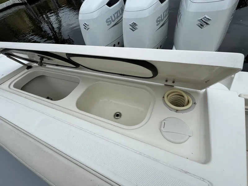 Slide: The Image of 2010 Hydra-Sports 3500 VX boat with open storage compartment and Suzuki outboard engines. - 24