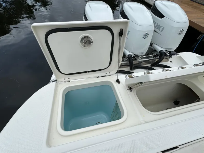 Slide: The Image of 2010 Hydra-Sports 3500 VX boat with open storage compartments and Suzuki outboard motors. - 28