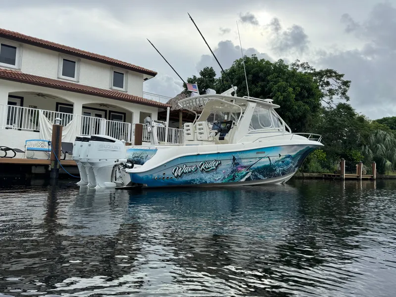 Slide: The Image of 2010 Hydra-Sports 3500 VX boat docked by a waterfront house. - 3