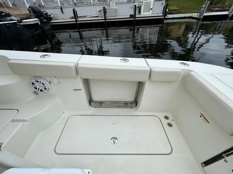 Slide: The Image of 2010 Hydra-Sports 3500 VX boat interior, featuring seating and storage near a dock. - 30