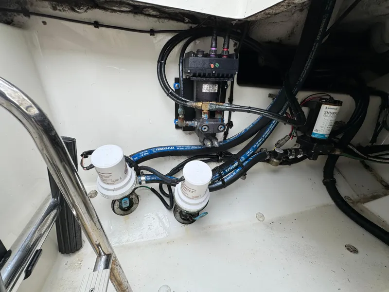 Slide: The Image of Engine compartment of a 2010 Hydra-Sports 3500 VX boat, showing fuel filters and wiring. - 34