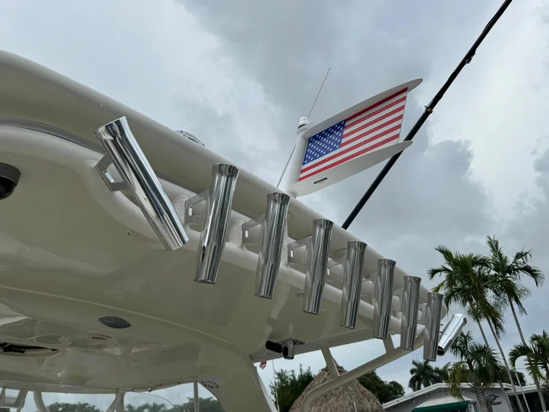 Slide: The Image of 2010 Hydra-Sports 3500 VX boat with rod holders and American flag, under cloudy sky. - 45