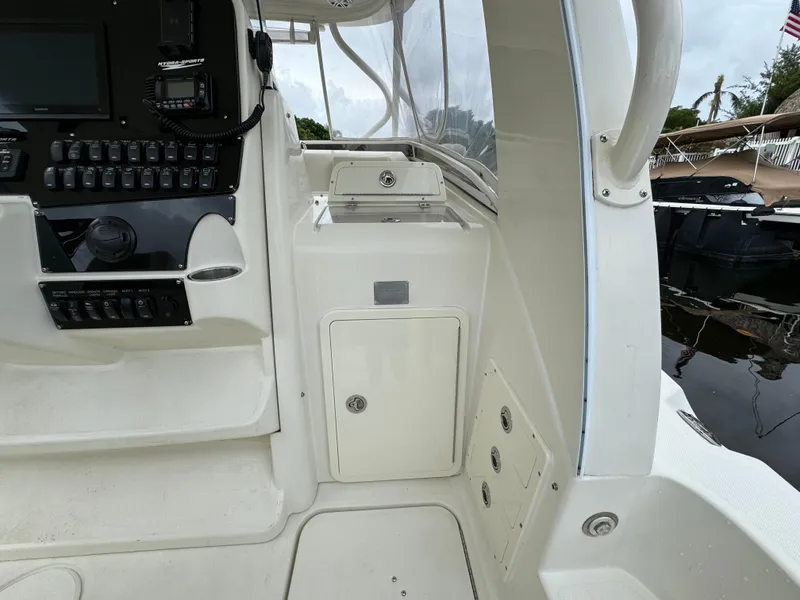 Slide: The Image of 2010 Hydra-Sports 3500 VX boat interior with control panel and storage compartments. - 47