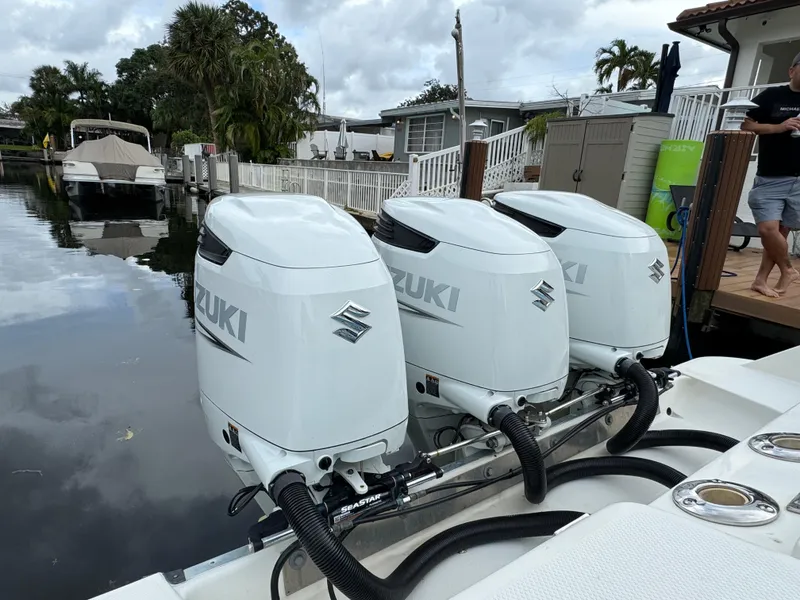 Slide: The Image of 2010 Hydra-Sports 3500 VX with triple Suzuki outboard motors docked by a canal. - 7