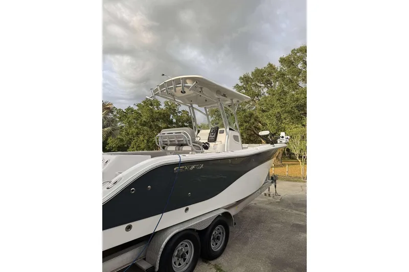 Slide: The Image of 2017 Sea Fox 266 Commander boat on trailer, parked outdoors under cloudy sky. - 11