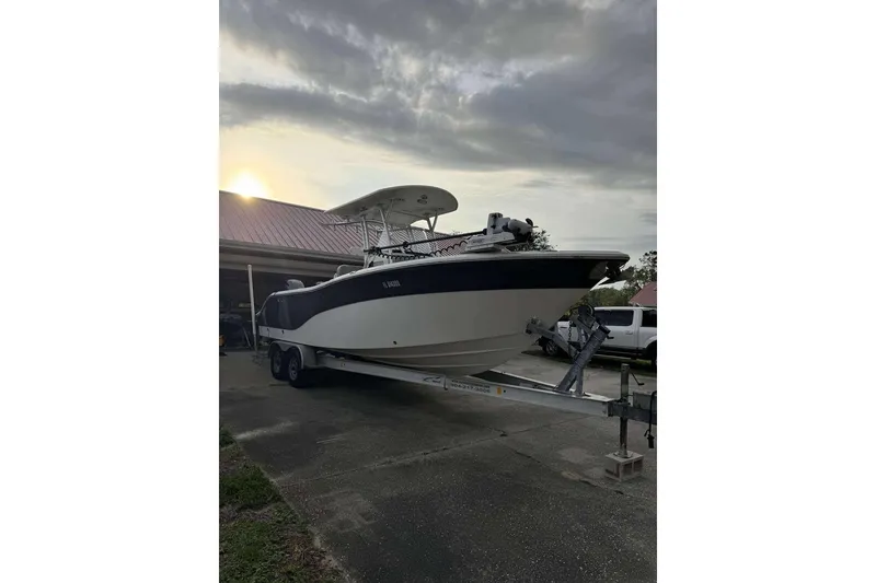 Slide: The Image of 2017 Sea Fox 266 Commander boat on trailer at sunset, parked near a house. - 12