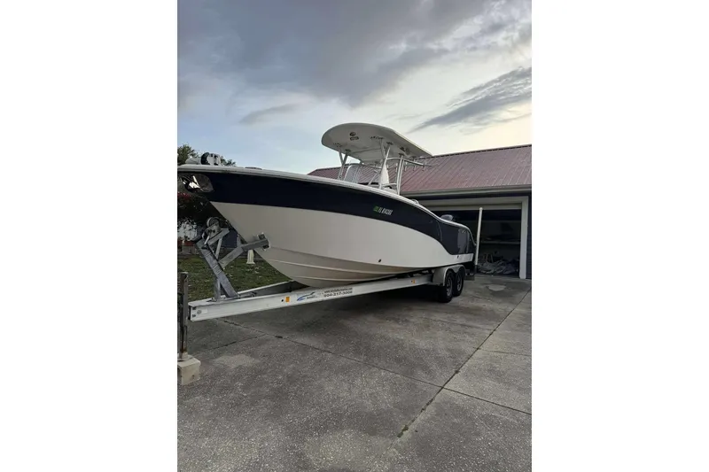 Slide: The Image of 2017 Sea Fox 266 Commander boat on trailer, parked in driveway near garage. - 13