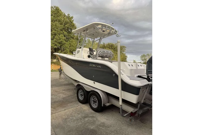 Slide: The Image of 2017 Sea Fox 266 Commander boat on trailer, parked outdoors under cloudy sky. - 14