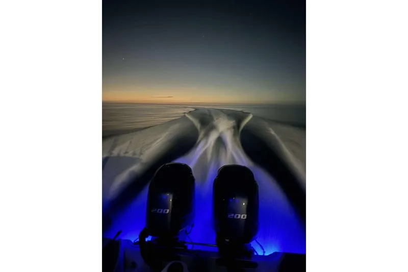 Slide: The Image of 2017 Sea Fox 266 Commander boat at dusk, illuminated wake and engines. - 18