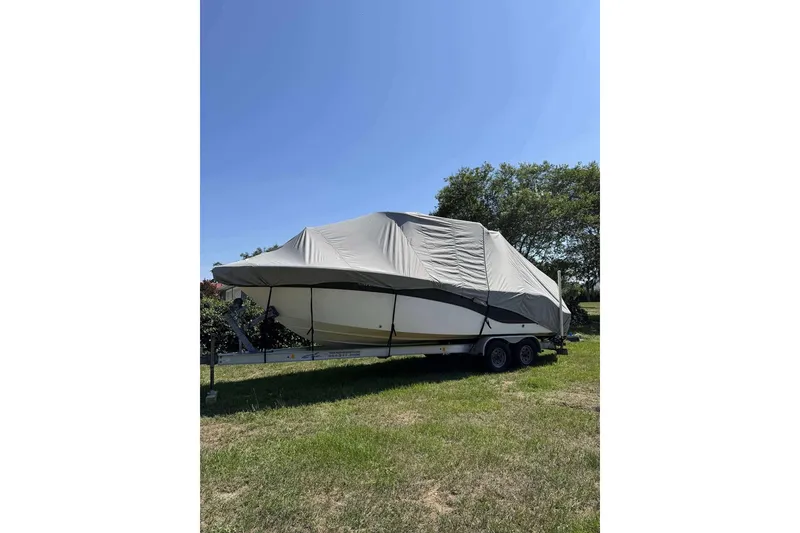 Slide: The Image of 2017 Sea Fox 266 Commander boat covered on trailer, parked on grass. - 25