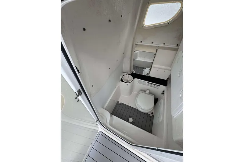 Slide: The Image of 2017 Sea Fox 266 Commander boat interior with compact marine toilet and window. - 8