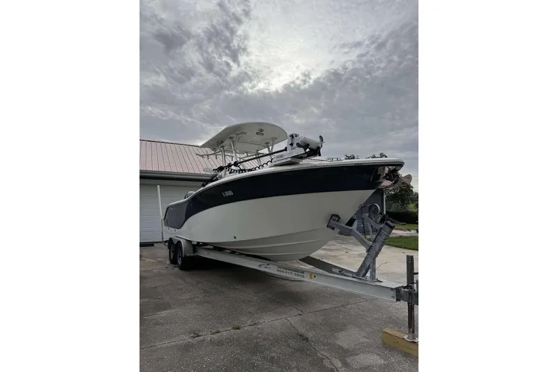 Slide: The Image of 2017 Sea Fox 266 Commander boat on trailer, parked outdoors under cloudy sky. - 9