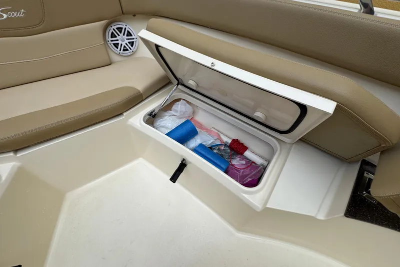 Slide: The Image of 2020 Scout 235 XSF boat storage compartment with various items inside. - 10