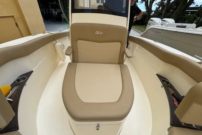 Slide: The Image of 2020 Scout 235 XSF boat interior with beige seating and cup holders. - 11