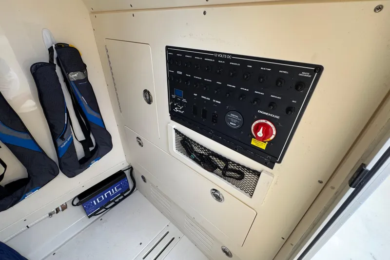 Slide: The Image of 2020 Scout 235 XSF boat control panel with storage and equipment. - 15