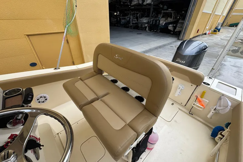 Slide: The Image of 2020 Scout 235 XSF boat interior with tan seating and Yamaha 250 outboard motor. - 21