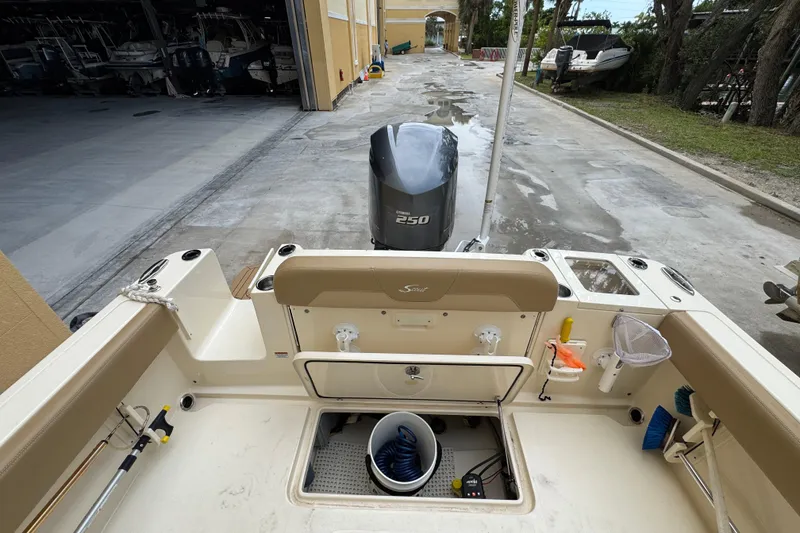 Slide: The Image of 2020 Scout 235 XSF boat interior with Yamaha 250 engine in a marina setting. - 22