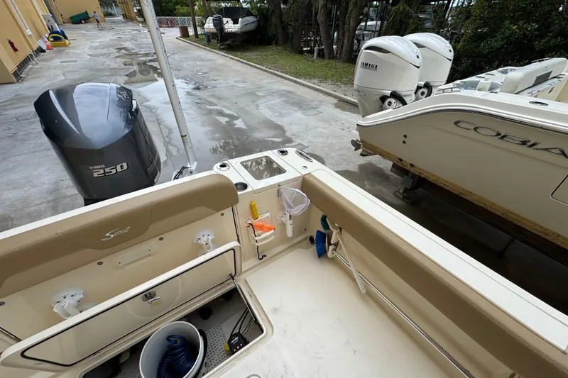 Slide: The Image of 2020 Scout 235 XSF boat with Yamaha 250 engine, docked beside Cobia boat. - 23