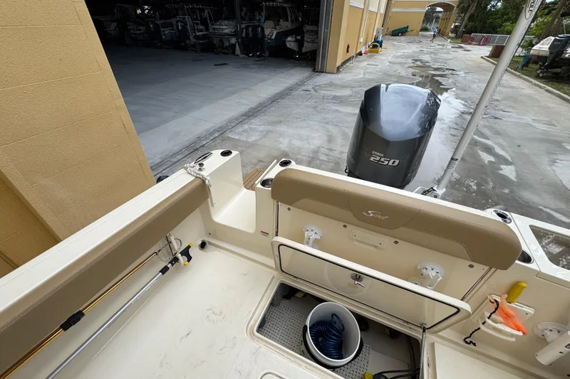 Slide: The Image of 2020 Scout 235 XSF boat with Yamaha 250 engine, docked near storage facility. - 24