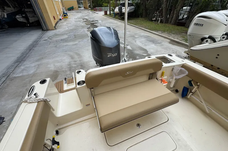Slide: The Image of 2020 Scout 235 XSF boat with Yamaha 250 engine, docked in a marina. - 25