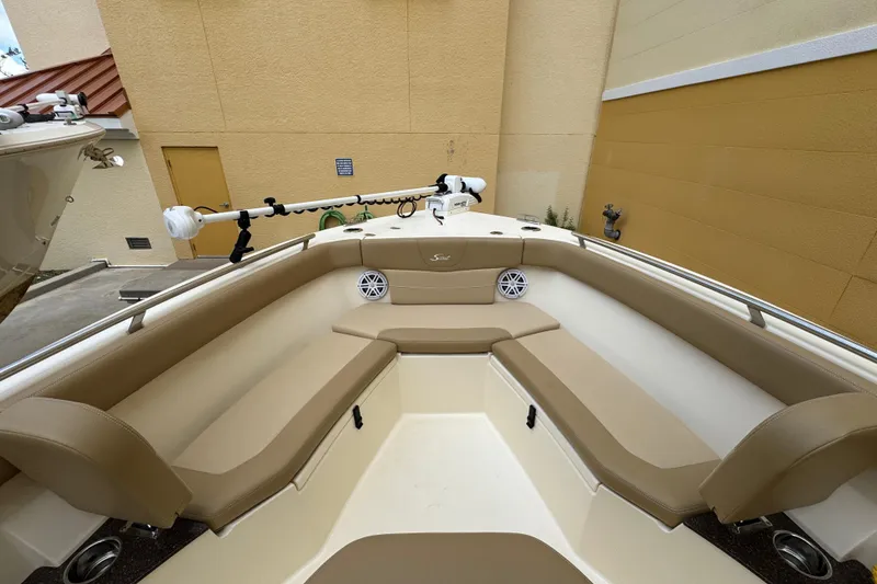 Slide: The Image of 2020 Scout 235 XSF boat interior with tan seating and mounted equipment. - 6