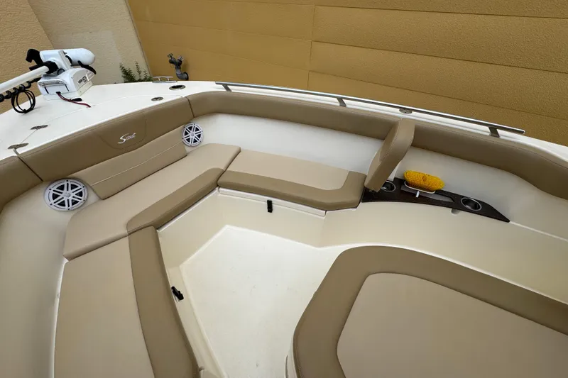 Slide: The Image of 2020 Scout 235 XSF boat interior with beige seating and speakers. - 7