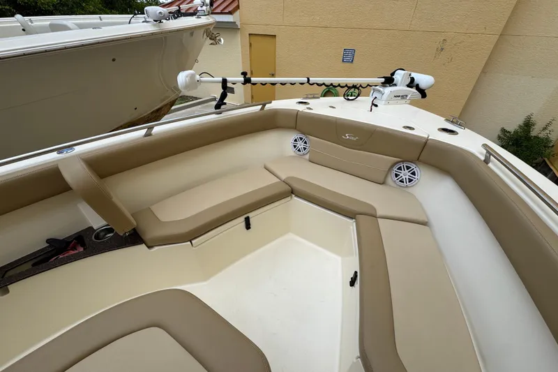 Slide: The Image of 2020 Scout 235 XSF boat interior with beige seating and mounted equipment. - 8
