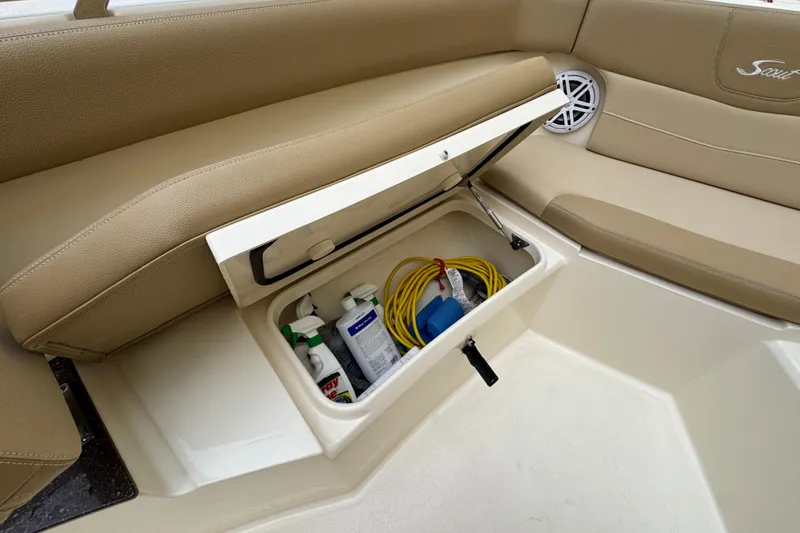 Slide: The Image of 2020 Scout 235 XSF boat storage compartment with cleaning supplies and equipment. - 9