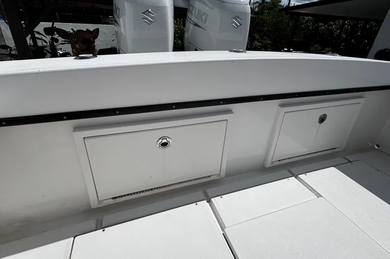 Slide: The Image of 2022 Whitewater 28 Open boat deck with storage compartments and Suzuki engines. - 14